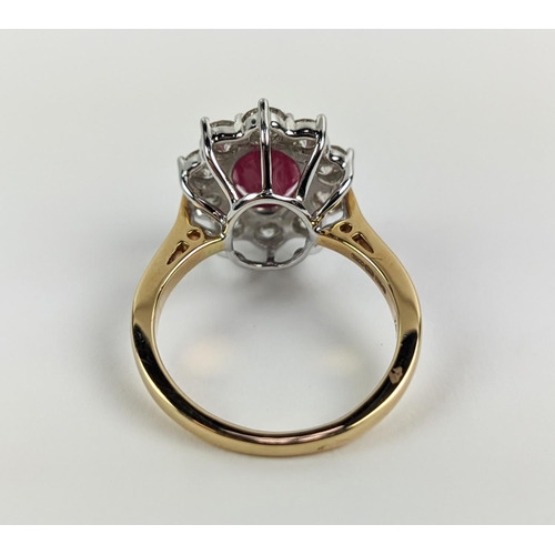 40 - AN 18CT GOLD RUBY AND DIAMOND CLUSTER RING, the central mixed cut ruby of approximately 2.25 carats,... 