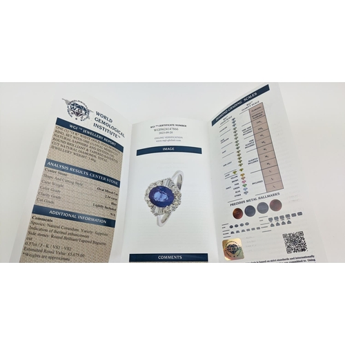 41 - AN 18CT WHITE GOLD SAPPHIRE AND DIAMOND HALO RING, the central oval mixed cut sapphire of approximat... 