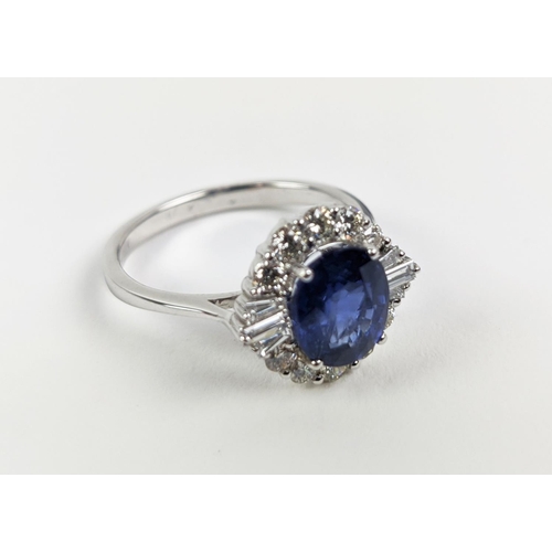 41 - AN 18CT WHITE GOLD SAPPHIRE AND DIAMOND HALO RING, the central oval mixed cut sapphire of approximat... 