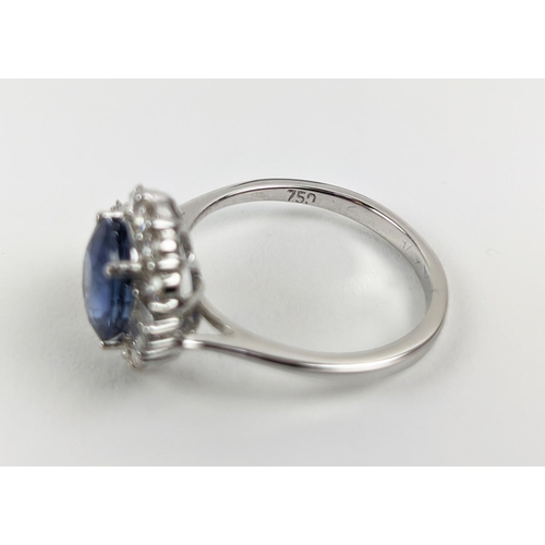 41 - AN 18CT WHITE GOLD SAPPHIRE AND DIAMOND HALO RING, the central oval mixed cut sapphire of approximat... 