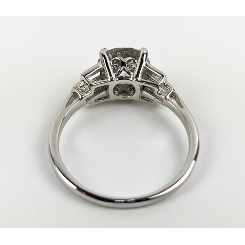 42 - AN 18CT WHITE GOLD DIAMOND SOLITAIRE RING, with baguette cut diamonds to shoulders, the central roun... 