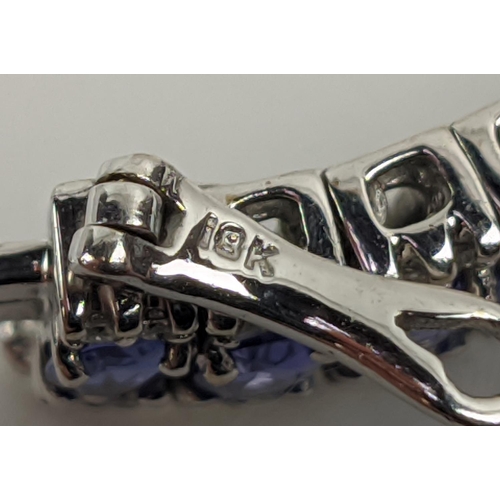 44 - AN 18CT WHITE GOLD TANZANITE AND DIAMOND BRACELET, set with sixty links, each link with a faceted ta... 