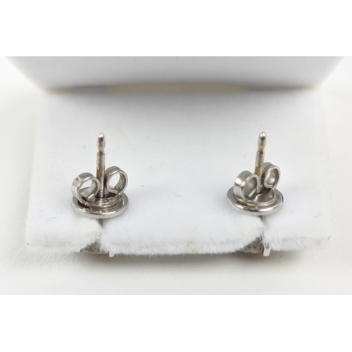 45 - A PAIR OF 18CT WHITE GOLD DIAMOND SOLITAIRE STUD EARRINGS, each with a claw set round brilliant cut ... 