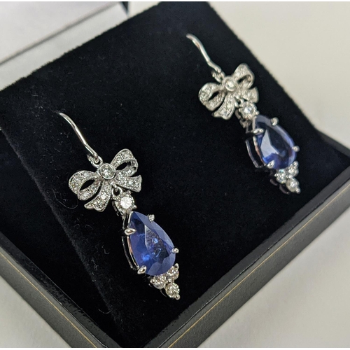 46 - A PAIR OF 18CT WHITE GOLD SAPPHIRE AND DIAMOND PENDANT EARRINGS, central pear shaped faceted sapphir... 