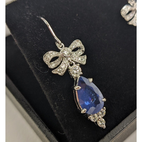 46 - A PAIR OF 18CT WHITE GOLD SAPPHIRE AND DIAMOND PENDANT EARRINGS, central pear shaped faceted sapphir... 