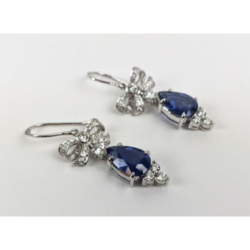 46 - A PAIR OF 18CT WHITE GOLD SAPPHIRE AND DIAMOND PENDANT EARRINGS, central pear shaped faceted sapphir... 