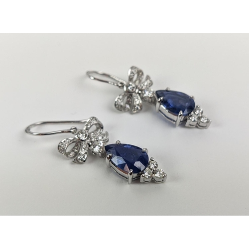 46 - A PAIR OF 18CT WHITE GOLD SAPPHIRE AND DIAMOND PENDANT EARRINGS, central pear shaped faceted sapphir... 