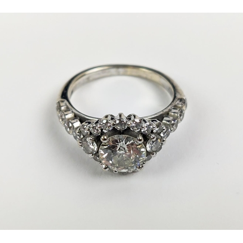 47 - A WHITE METAL DIAMOND SET DRESS RING, probably 18ct white gold, the large round brilliant cut centra... 