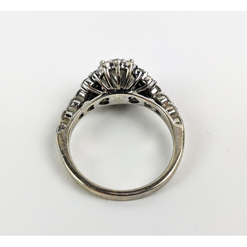 47 - A WHITE METAL DIAMOND SET DRESS RING, probably 18ct white gold, the large round brilliant cut centra... 