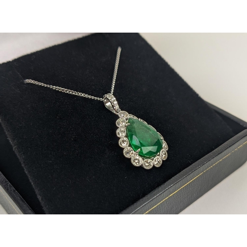 48 - AN 18CT WHITE AND YELLOW METAL EMERALD AND DIAMOND PENDANT NECKLACE, the pendant with a pear-shaped ... 