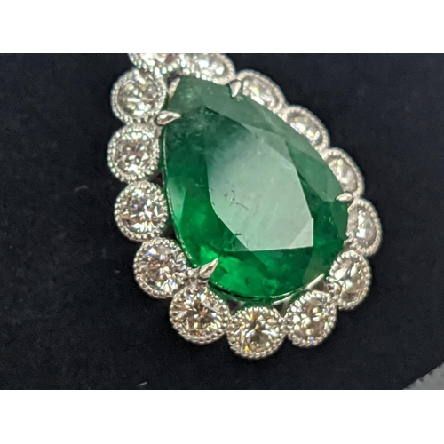 48 - AN 18CT WHITE AND YELLOW METAL EMERALD AND DIAMOND PENDANT NECKLACE, the pendant with a pear-shaped ... 