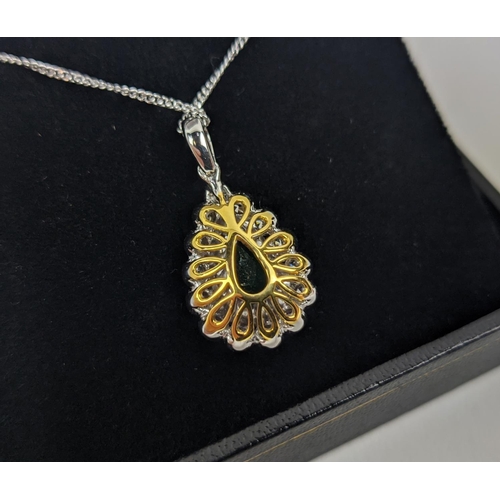 48 - AN 18CT WHITE AND YELLOW METAL EMERALD AND DIAMOND PENDANT NECKLACE, the pendant with a pear-shaped ... 