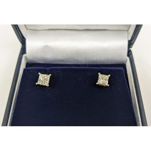 34 - A PAIR OF 18CT WHITE DIAMOND SOLITAIRE STUD EARRINGS, each with princess cut diamonds of approximate... 