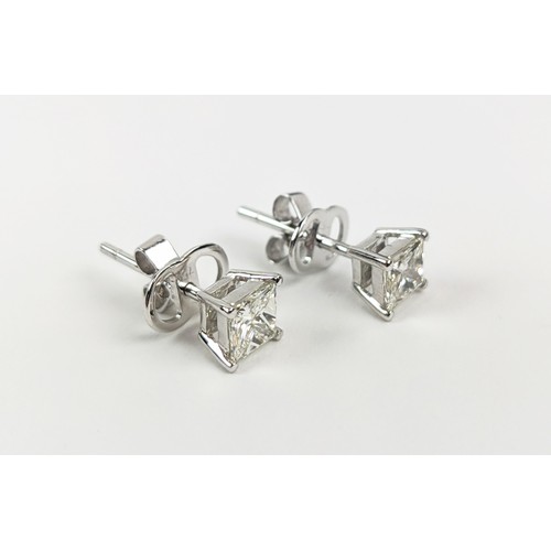 34 - A PAIR OF 18CT WHITE DIAMOND SOLITAIRE STUD EARRINGS, each with princess cut diamonds of approximate... 