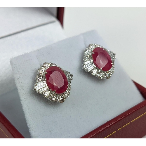 35 - A PAIR OF 18CT WHITE GOLD RUBY AND DIAMOND STUD EARRINGS, the central mixed cut stones of approximat... 