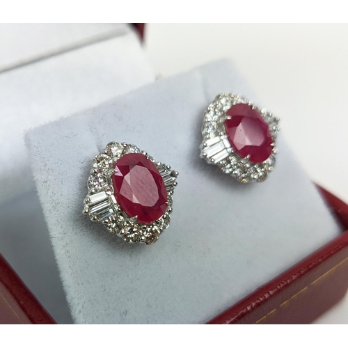 35 - A PAIR OF 18CT WHITE GOLD RUBY AND DIAMOND STUD EARRINGS, the central mixed cut stones of approximat... 