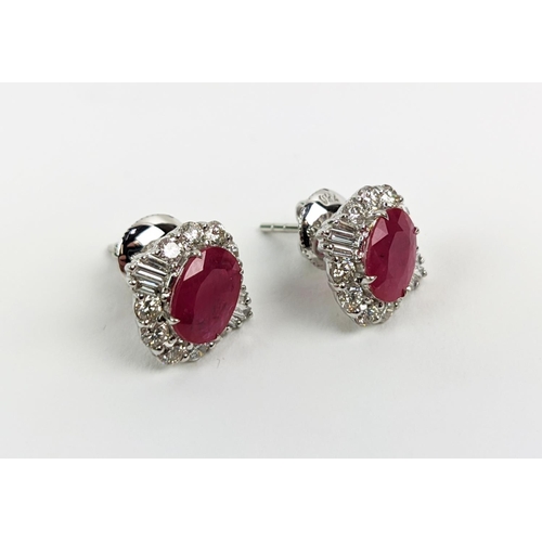 35 - A PAIR OF 18CT WHITE GOLD RUBY AND DIAMOND STUD EARRINGS, the central mixed cut stones of approximat... 