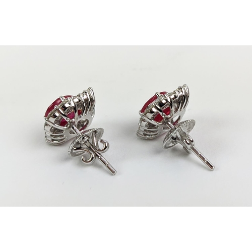 35 - A PAIR OF 18CT WHITE GOLD RUBY AND DIAMOND STUD EARRINGS, the central mixed cut stones of approximat... 