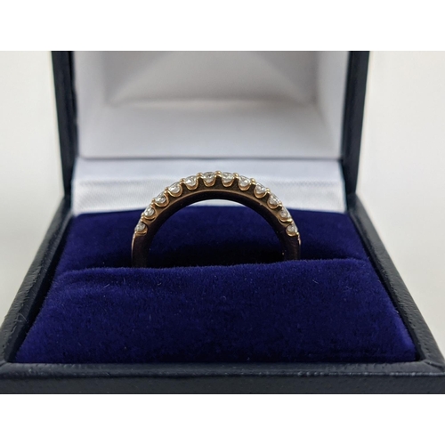 53 - AN 18CT GOLD DIAMOND HALF ETERNITY RING, set with twelve round brilliant cut diamonds, ring size M, ... 