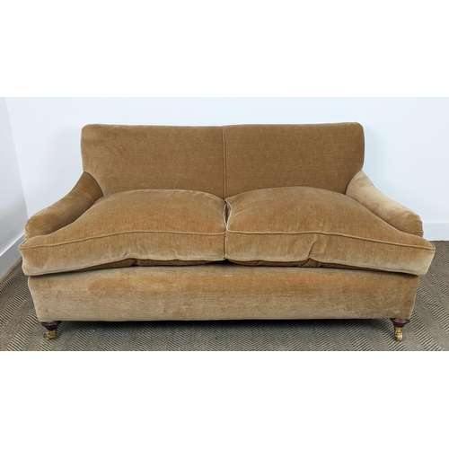 584 - HOWARD STYLE SOFA, tan coloured velvet on brass castors, 77cm H x 165cm W x 97cm D.