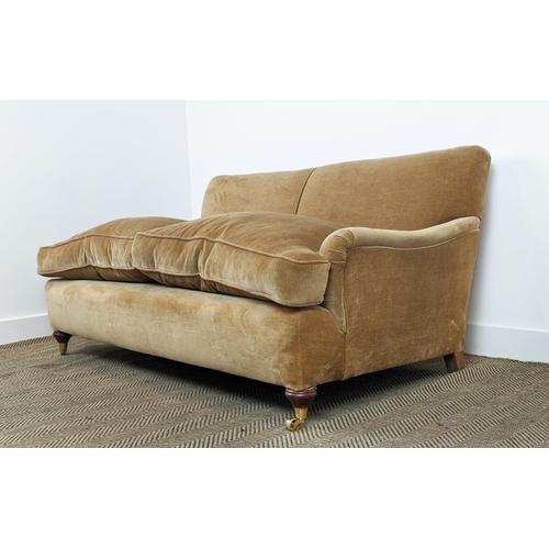 584 - HOWARD STYLE SOFA, tan coloured velvet on brass castors, 77cm H x 165cm W x 97cm D.