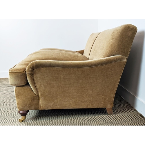 584 - HOWARD STYLE SOFA, tan coloured velvet on brass castors, 77cm H x 165cm W x 97cm D.