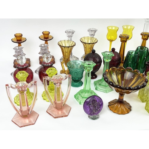 12 - QUANTITY OF URANIUM GLASS, various items including pairs of candlesticks, jugs, lidded vases, bottle... 