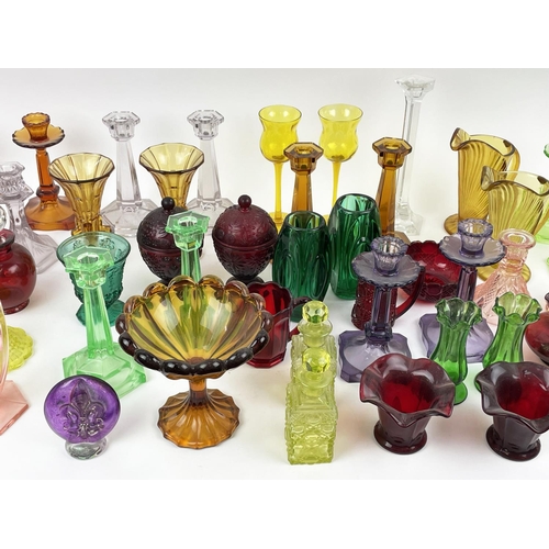 12 - QUANTITY OF URANIUM GLASS, various items including pairs of candlesticks, jugs, lidded vases, bottle... 