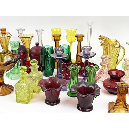 12 - QUANTITY OF URANIUM GLASS, various items including pairs of candlesticks, jugs, lidded vases, bottle... 