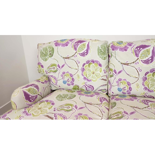 223 - SOFA, purple and green floral patterned on brass castors, 90cm H x 160cm W.