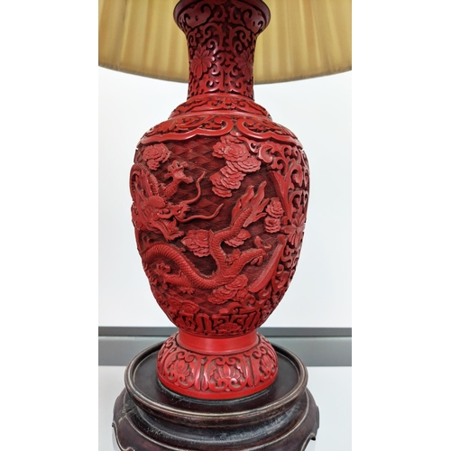 4 - CINNABAR STYLE LACQUER LAMP, early 20th century, carved with a fine claw dragon on a rosewood carved... 