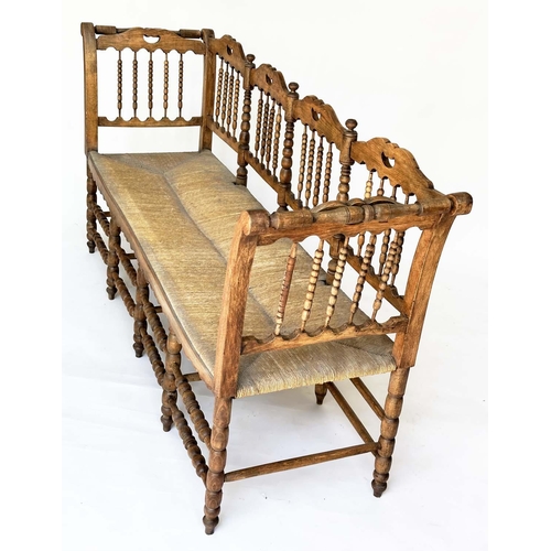 129 - HALL SEAT, 19th century English, William Morris style fruitwood with bobbin turned frame and rush se... 