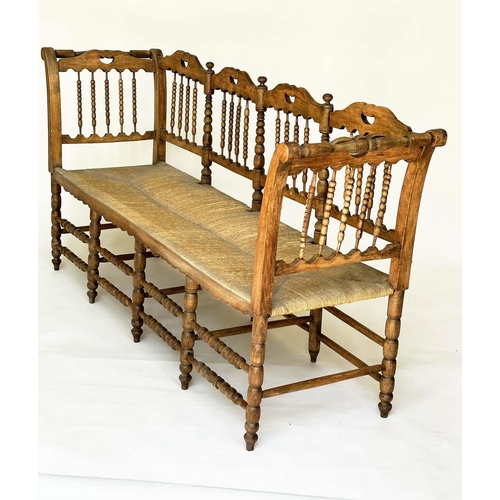 129 - HALL SEAT, 19th century English, William Morris style fruitwood with bobbin turned frame and rush se... 