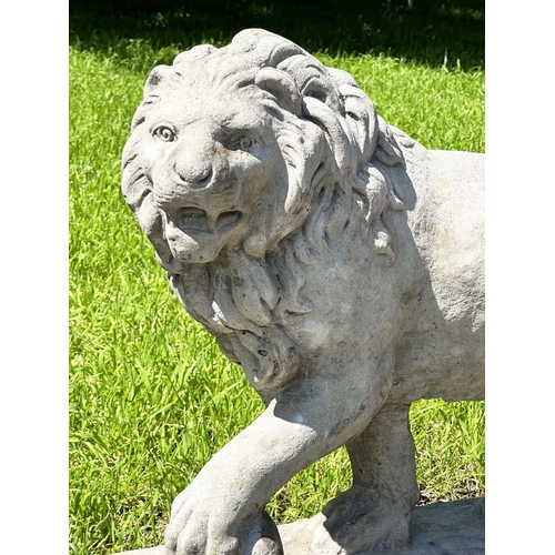 136 - GARDEN LIONS, a pair, weathered reconstituted stone, 58cm H x 70cm W. (2)