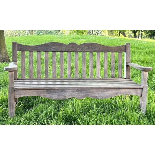 137 - GARDEN BENCH BY 'BRIDGMAN AND CO', well weathered teak slatted with shaped yoke and shaped flat top ... 