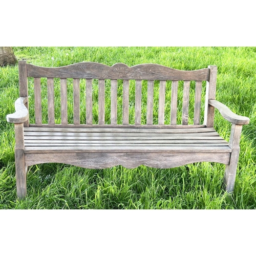 137 - GARDEN BENCH BY 'BRIDGMAN AND CO', well weathered teak slatted with shaped yoke and shaped flat top ... 