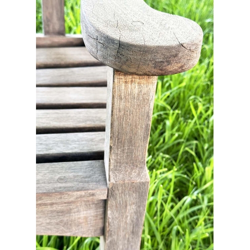 137 - GARDEN BENCH BY 'BRIDGMAN AND CO', well weathered teak slatted with shaped yoke and shaped flat top ... 