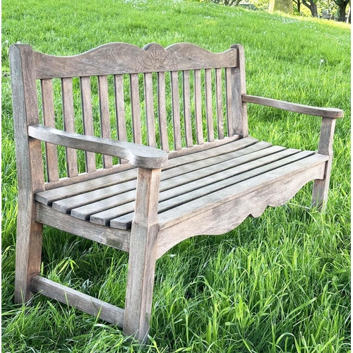 137 - GARDEN BENCH BY 'BRIDGMAN AND CO', well weathered teak slatted with shaped yoke and shaped flat top ... 