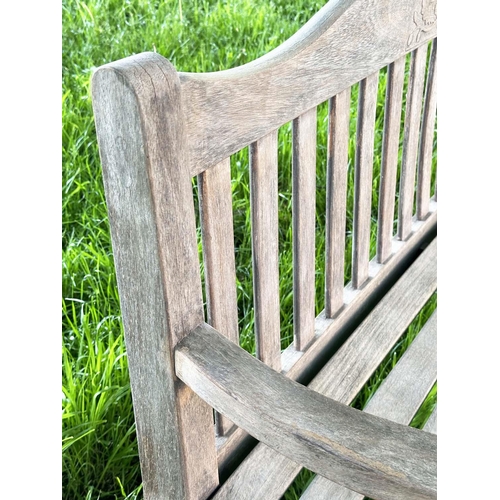 137 - GARDEN BENCH BY 'BRIDGMAN AND CO', well weathered teak slatted with shaped yoke and shaped flat top ... 