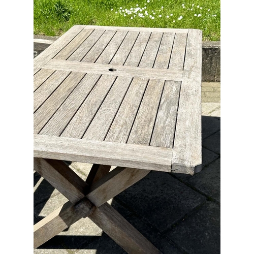 140 - GARDEN SET BY WOODFERN, well weathered teak with substantial X frame table, 72cm H x 152cm W x 86cm ... 