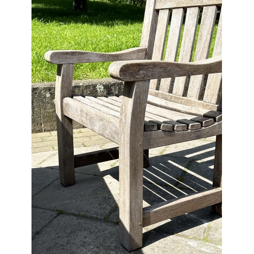 140 - GARDEN SET BY WOODFERN, well weathered teak with substantial X frame table, 72cm H x 152cm W x 86cm ... 