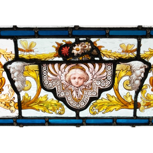 182 - STAINED GLASS PANEL, mask and foliate scroll design in painted frame, 35cm H x 91cm.