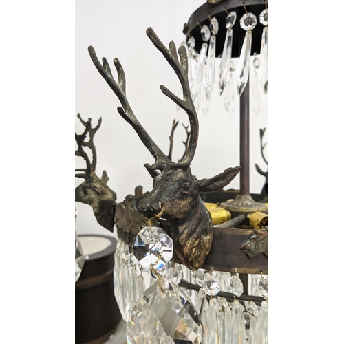 176 - CHANDELIER, gilt metal with stag heads, glass drops and six lights, 53cm W x 85cm H overall.