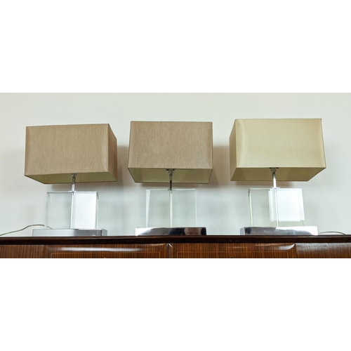 544 - TABLE LAMPS, a set of three, glass on polished metal bases, each 52cm H overall including shades. (3... 