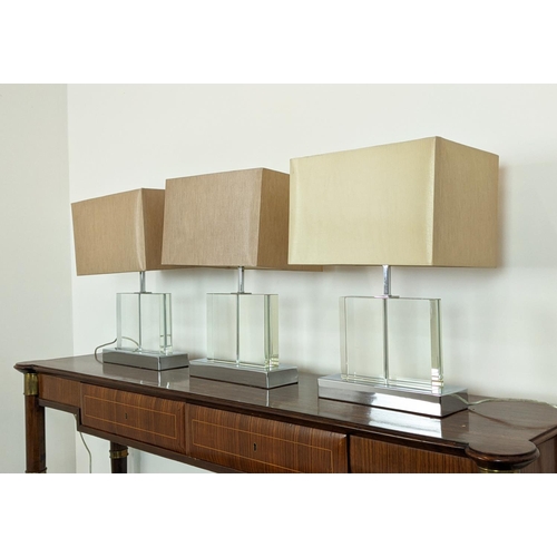 544 - TABLE LAMPS, a set of three, glass on polished metal bases, each 52cm H overall including shades. (3... 