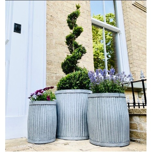 403 - PLANTERS, a graduated set of three, in ribbed galvanised metal, largest 50cm H x 45cm x 45cm. (3)