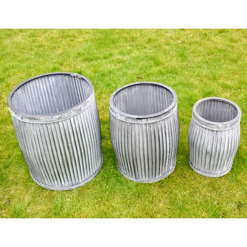 403 - PLANTERS, a graduated set of three, in ribbed galvanised metal, largest 50cm H x 45cm x 45cm. (3)