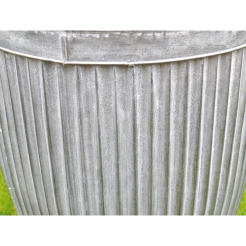 403 - PLANTERS, a graduated set of three, in ribbed galvanised metal, largest 50cm H x 45cm x 45cm. (3)