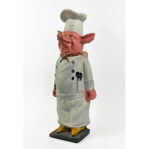 23 - CAST IRON PIG, in chef's whites, 59cm H.