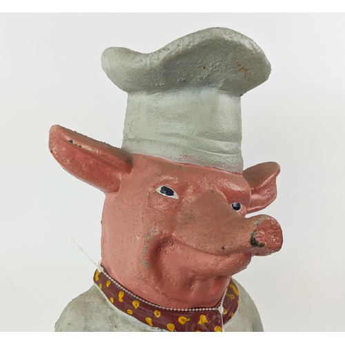 23 - CAST IRON PIG, in chef's whites, 59cm H.